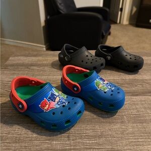 Kids Crocs- Blue and Red paw patrol and a pair of black ones.